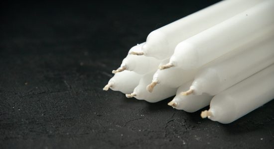 front-view-white-candles-black
