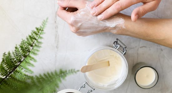 top-view-woman-using-cream-her-hands