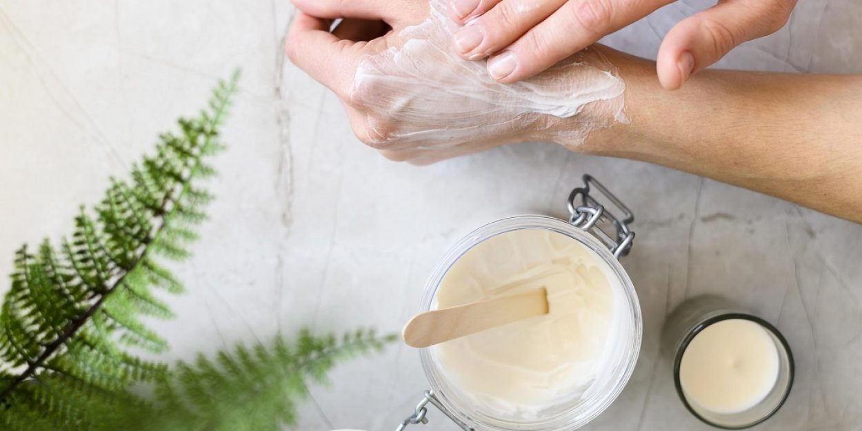 top-view-woman-using-cream-her-hands